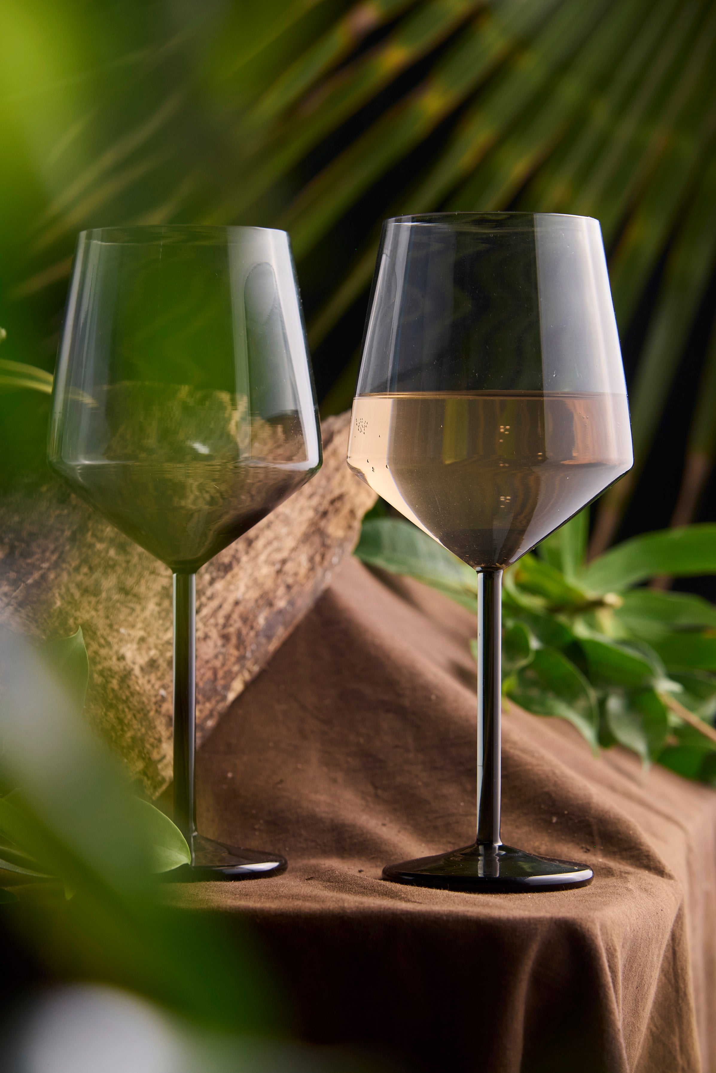 Coloured diamond wine glass handmade designer glassware Close-up of coloured diamond cut wine glass design Luxury coloured diamond wine glass for modern table setting Coloured diamond wine glass with faceted crystal design