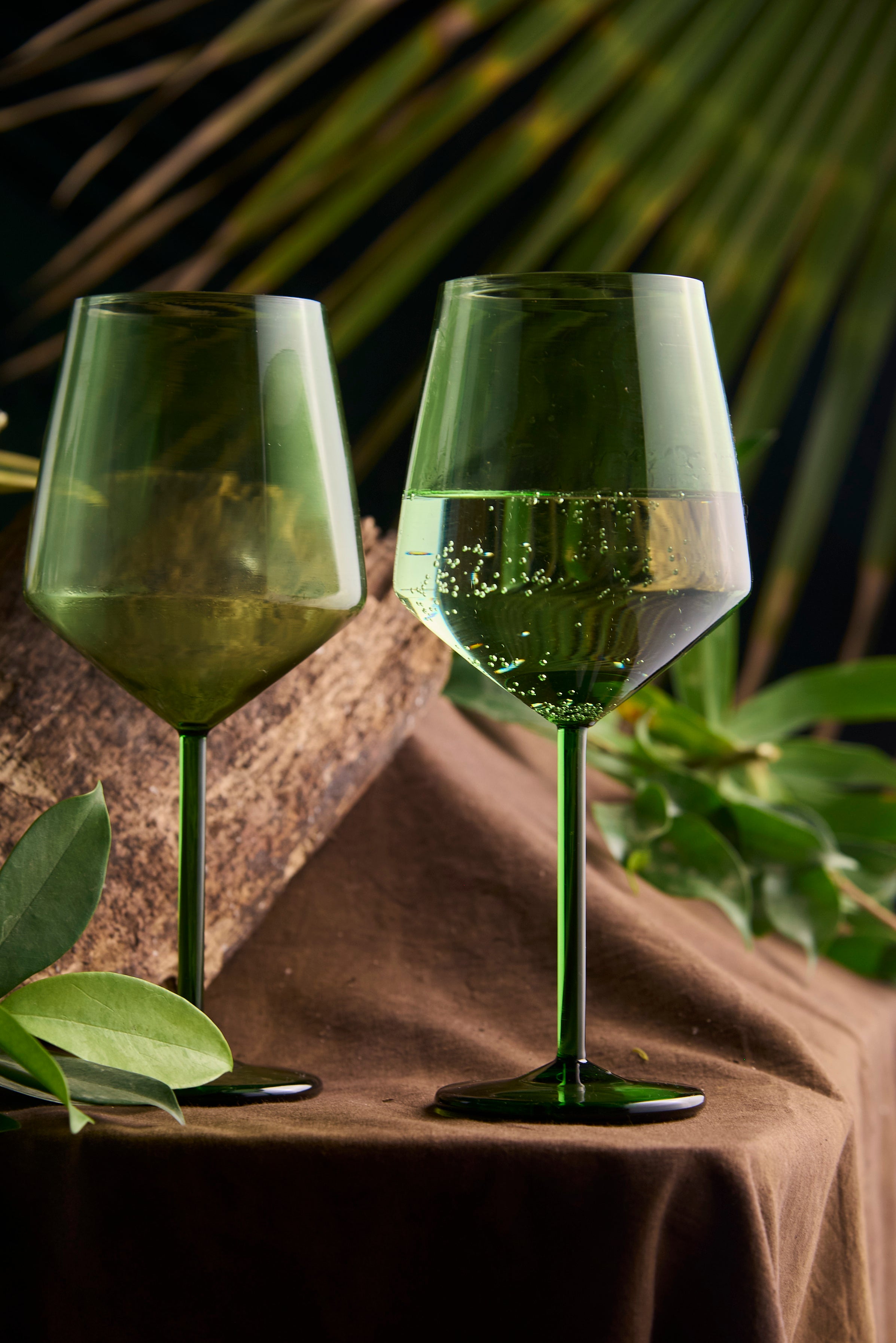 Coloured diamond wine glass handmade designer glassware Close-up of coloured diamond cut wine glass design Luxury coloured diamond wine glass for modern table setting Coloured diamond wine glass with faceted crystal design