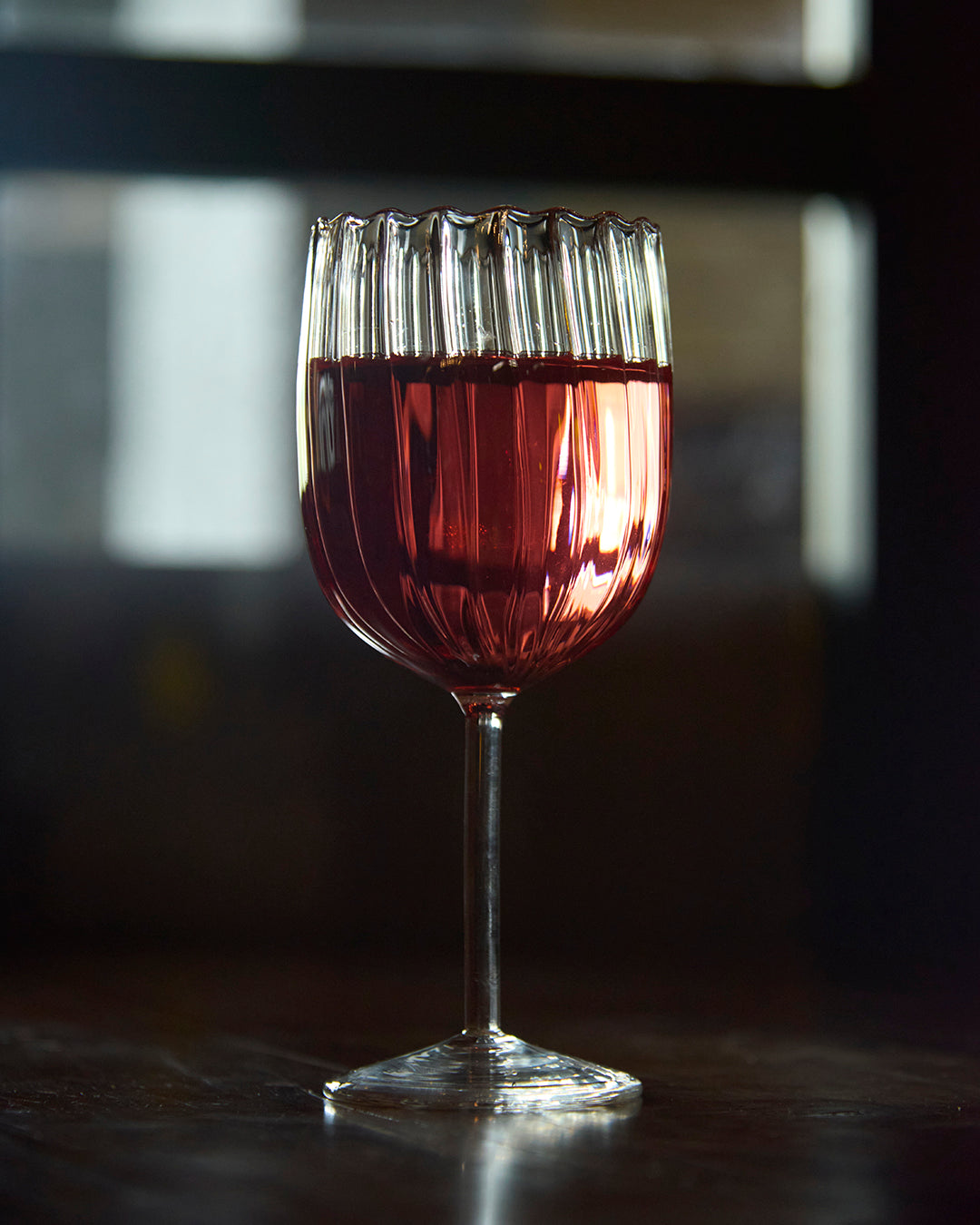 Ribbed pristine fluted wine glass elegant textured clear glassware Wine served in ribbed fluted glass Premium clear glass ribbed fluted wine glass durable stemware