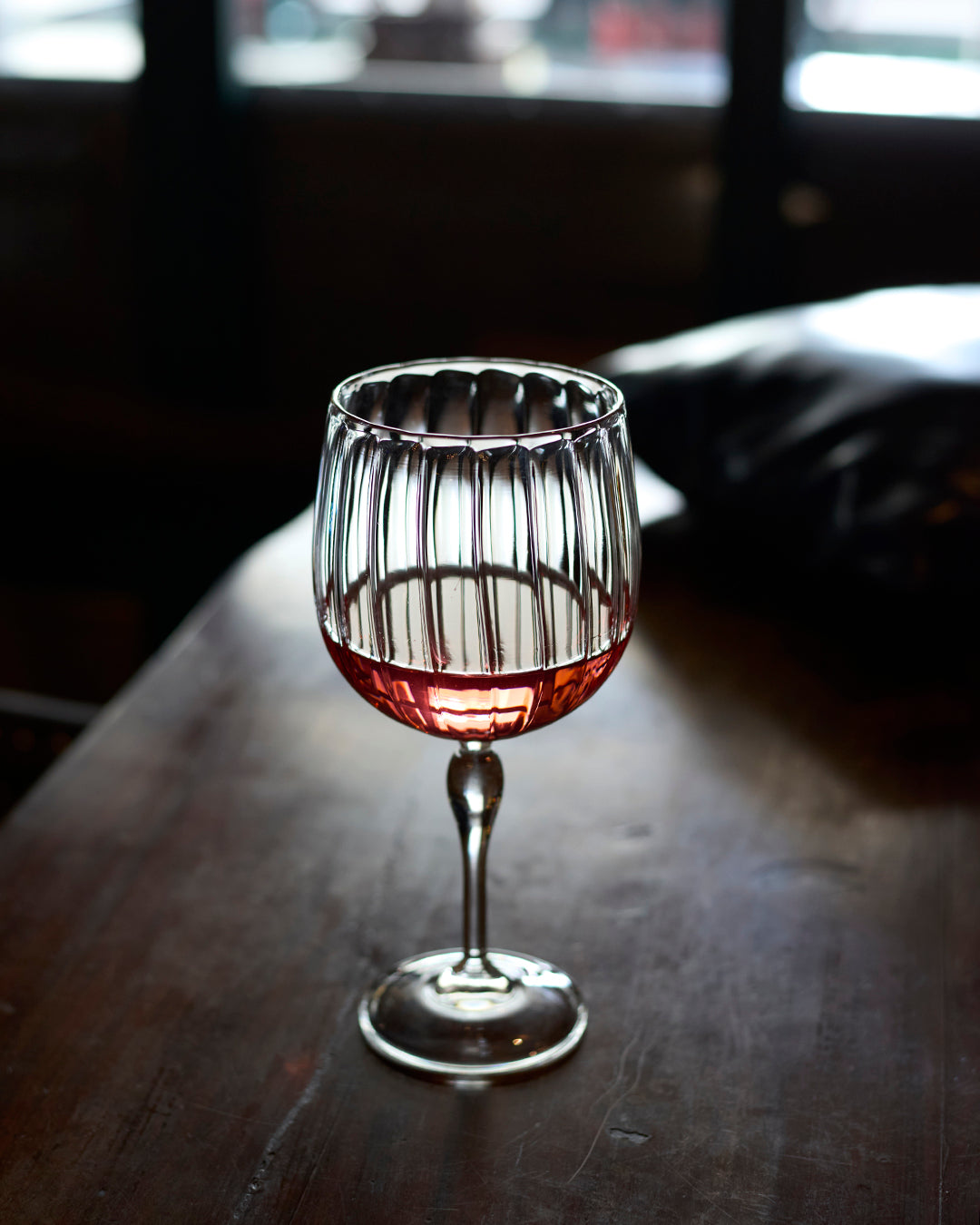 Vintage curves fluted mocktail glass elegant clear glass drinkware Elegant fluted glass for mocktails cocktails and cold beverages Decorative curved fluted glass for stylish drink presentation Elegant vintage mocktail drinkware