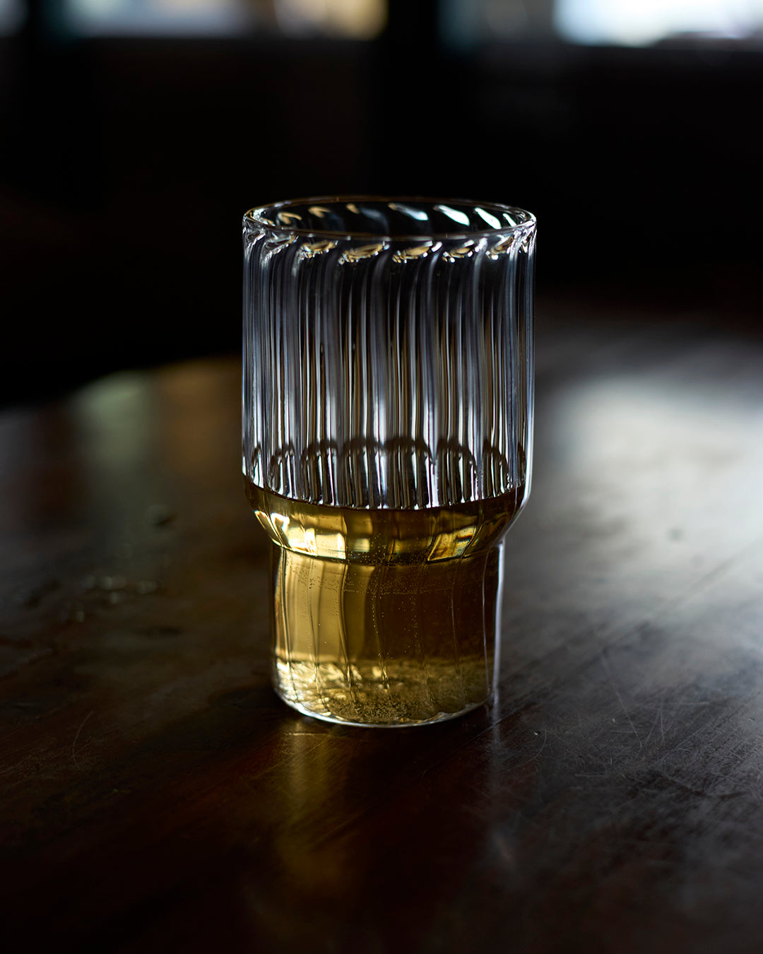 Fluted water glass on modern dining table handmade fluted water glass fluted drinking glass ribbed water glass